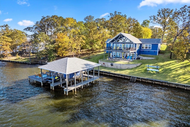 dock area with a lawn, a balcony, and a deck with water view