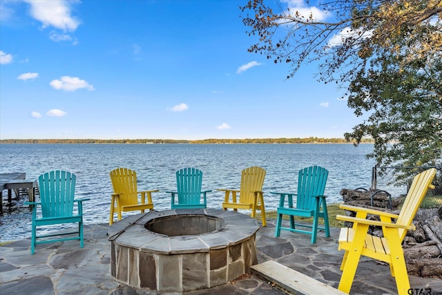 view of patio featuring a water view and an outdoor fire pit