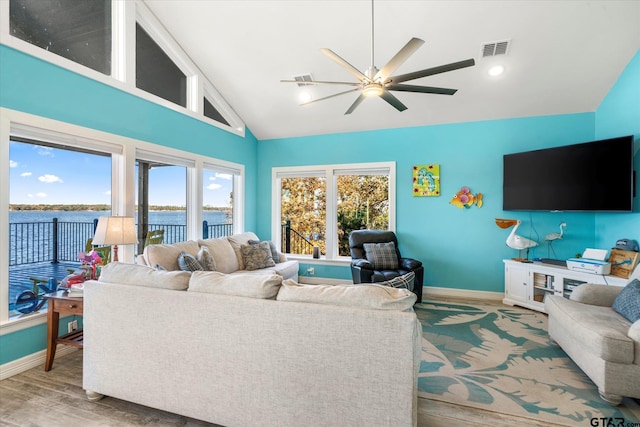 living room featuring wood-type flooring, high vaulted ceiling, and ceiling fan