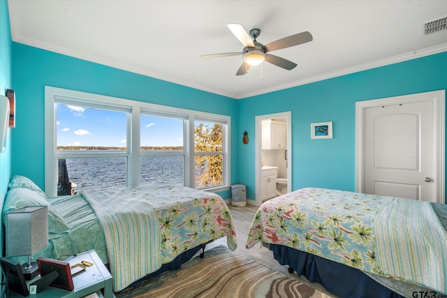 bedroom with a water view, ceiling fan, crown molding, and ensuite bathroom