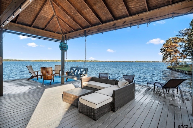 dock area featuring a gazebo, a deck with water view, and an outdoor hangout area