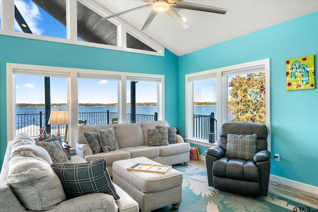 living room with high vaulted ceiling, a water view, ceiling fan, beam ceiling, and wood-type flooring