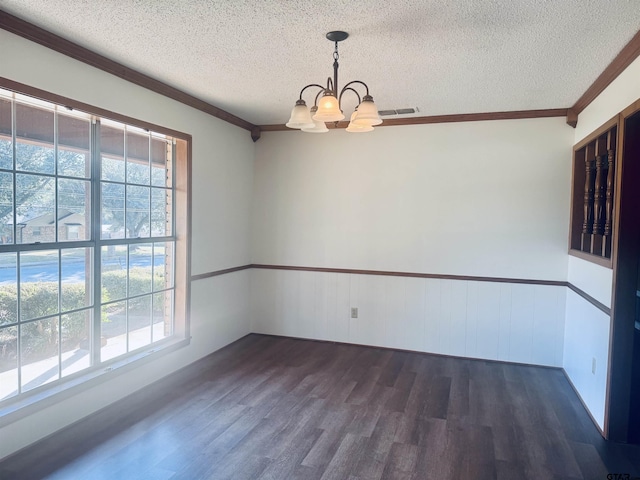 unfurnished room featuring a chandelier, dark hardwood / wood-style flooring, a textured ceiling, and crown molding