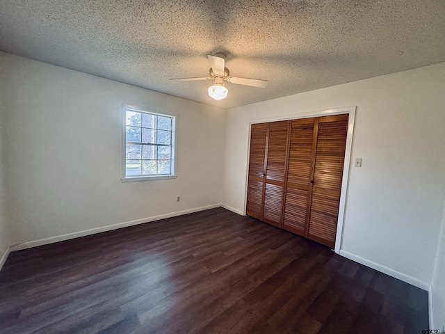 unfurnished bedroom featuring a textured ceiling, a closet, ceiling fan, and dark hardwood / wood-style floors