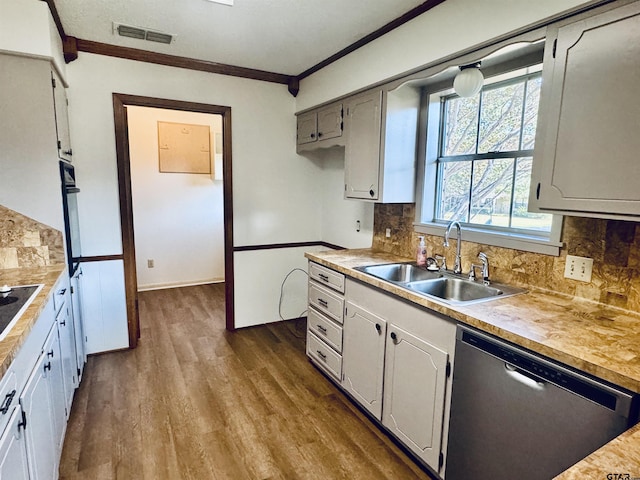 kitchen featuring dishwasher, sink, ornamental molding, and backsplash