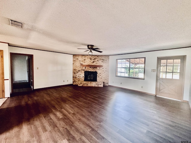 unfurnished living room with hardwood / wood-style floors, a textured ceiling, a brick fireplace, and ceiling fan