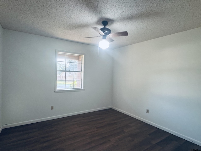 unfurnished room with ceiling fan, dark hardwood / wood-style flooring, and a textured ceiling