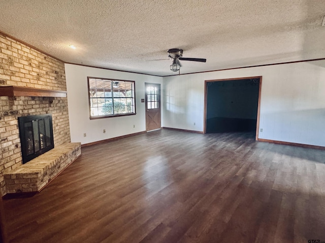 unfurnished living room featuring a fireplace, ceiling fan, dark hardwood / wood-style flooring, and a textured ceiling