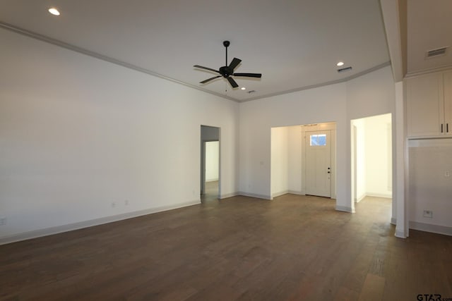 spare room featuring ceiling fan, crown molding, dark hardwood / wood-style floors, and a towering ceiling