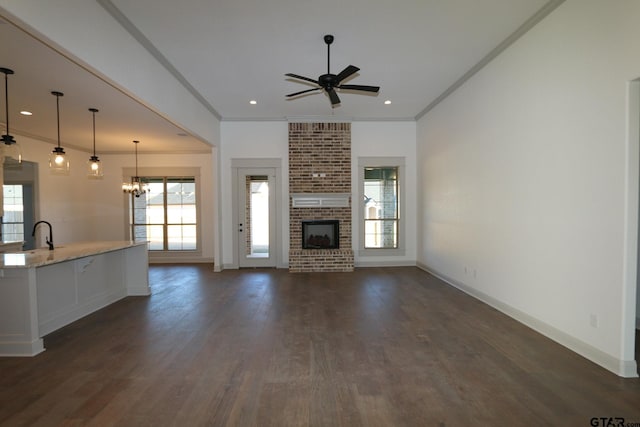 unfurnished living room with a fireplace, a wealth of natural light, and ornamental molding