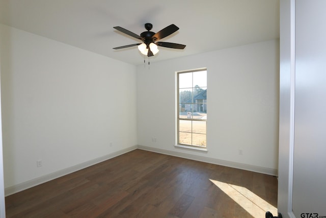 unfurnished room featuring dark wood-type flooring, plenty of natural light, and ceiling fan