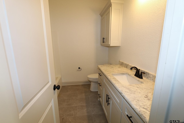 bathroom featuring toilet and vanity