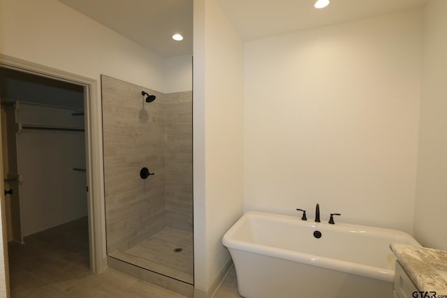 bathroom with vanity and separate shower and tub