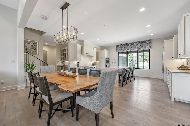 7612 Crosswater, Tyler, TX 75703 - dining room with baseboards, recessed lighting, light wood-style floors, stairs, and a chandelier