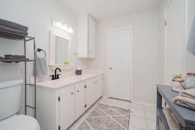 bathroom featuring tile patterned floors, vanity, and toilet