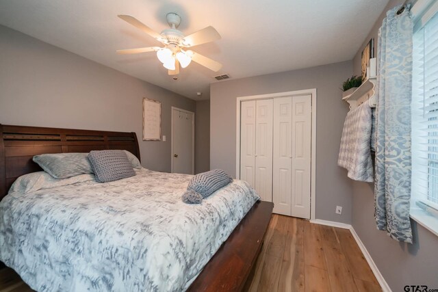 bedroom featuring ceiling fan, a closet, and hardwood / wood-style flooring