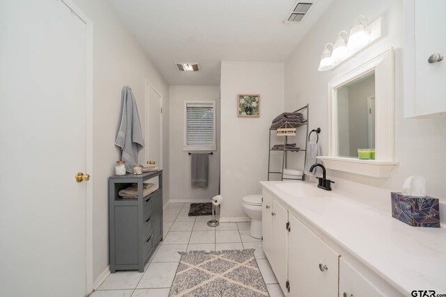 bathroom with tile patterned floors, vanity, and toilet