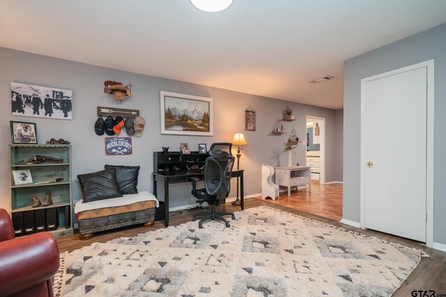 office space with wood-type flooring