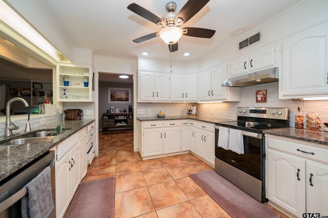 kitchen with sink, white cabinetry, stainless steel appliances, and dark stone counters