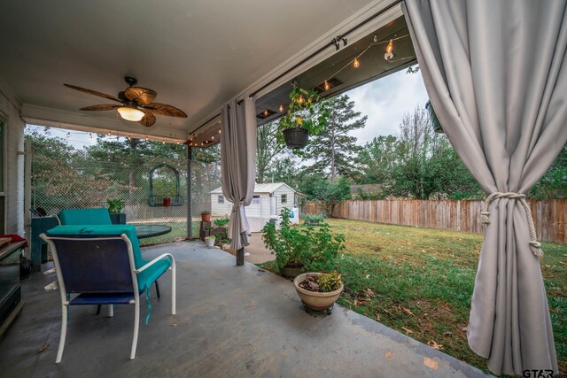 view of patio / terrace featuring ceiling fan and a shed