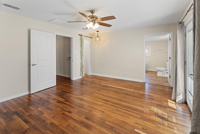 unfurnished bedroom with baseboards, visible vents, and wood finished floors