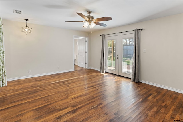 spare room featuring ceiling fan, visible vents, baseboards, french doors, and wood-type flooring