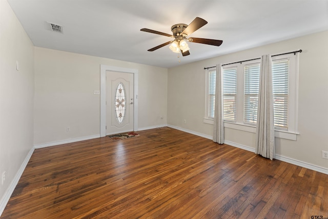 spare room with baseboards, visible vents, and hardwood / wood-style floors