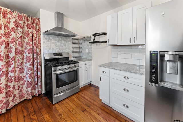 kitchen featuring white cabinetry, wall chimney range hood, appliances with stainless steel finishes, open shelves, and dark wood finished floors