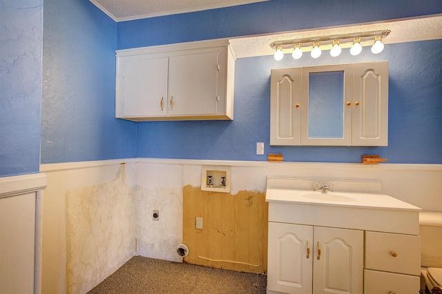 bathroom with ornamental molding and vanity