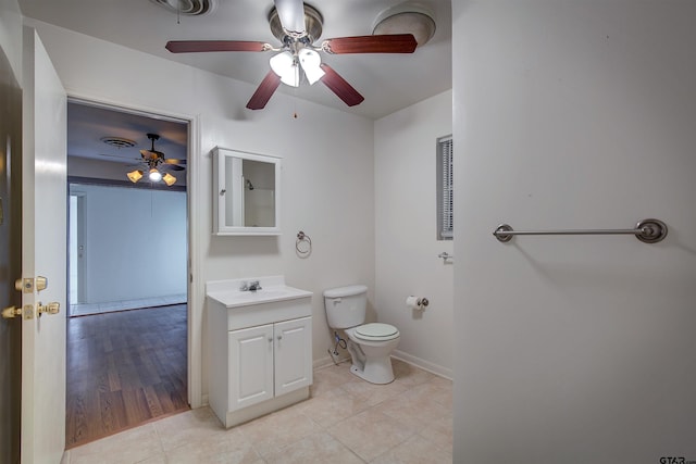 bathroom featuring hardwood / wood-style floors, vanity, ceiling fan, and toilet