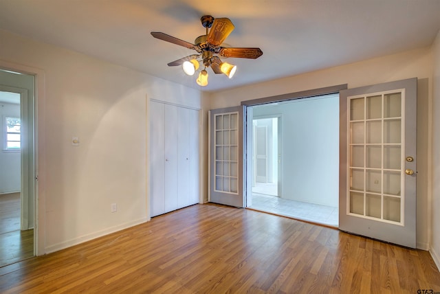 unfurnished bedroom featuring light hardwood / wood-style flooring and ceiling fan