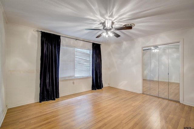 unfurnished bedroom with ceiling fan, a closet, and light wood-type flooring