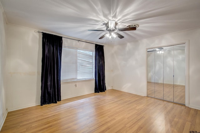 214 County Road 1900, Yantis, TX 75497 - unfurnished bedroom featuring light wood finished floors, ceiling fan, a closet, and baseboards