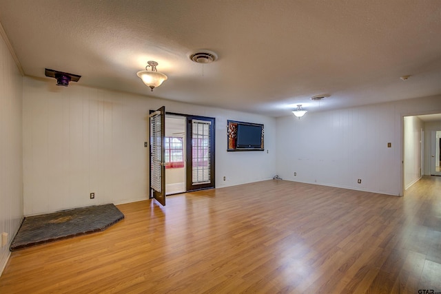 empty room featuring hardwood / wood-style floors and a textured ceiling