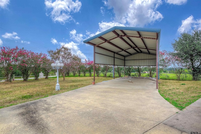 view of parking with a yard and a carport