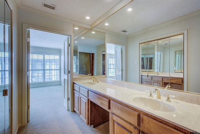 bathroom featuring vanity, a textured ceiling, and ornamental molding