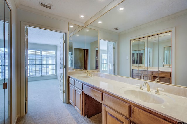 214 County Road 1900, Yantis, TX 75497 - bathroom with double vanity, crown molding, recessed lighting, and a textured ceiling
