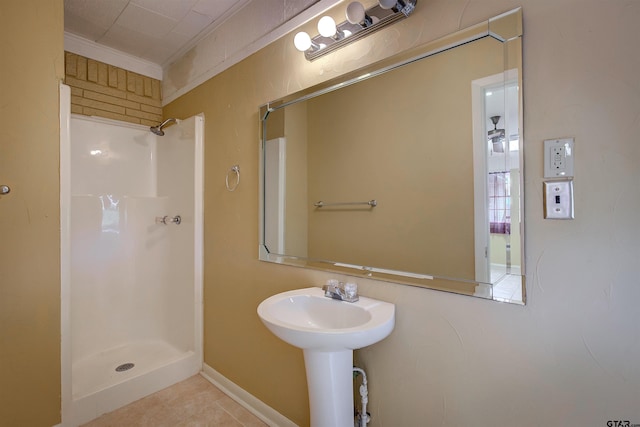 bathroom with ornamental molding, walk in shower, and tile patterned floors