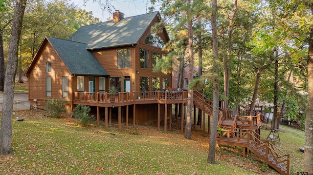 207 S King Laurence Ct, Scroggins, TX 75480 - rear view of property featuring stairway, a wooden deck, and a lawn