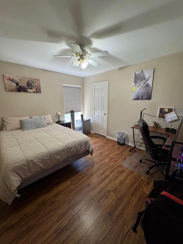 bedroom featuring baseboards, a ceiling fan, and wood finished floors