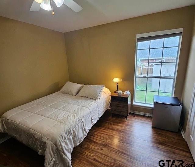 306 Cameron St, Whitehouse, TX 75791 - bedroom with dark wood-style floors, multiple windows, refrigerator, and a ceiling fan