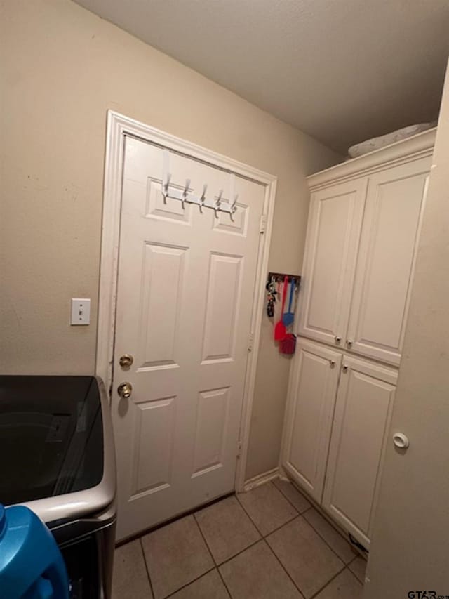 306 Cameron St, Whitehouse, TX 75791 - doorway with light tile patterned floors and washer / dryer