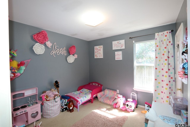 bedroom featuring carpet flooring and baseboards