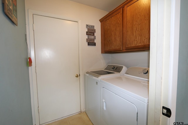 washroom with cabinet space and washing machine and clothes dryer