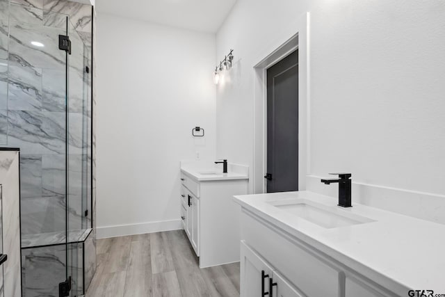 bathroom featuring hardwood / wood-style floors, vanity, and an enclosed shower