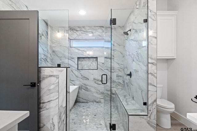 bathroom with shower with separate bathtub, toilet, and wood-type flooring