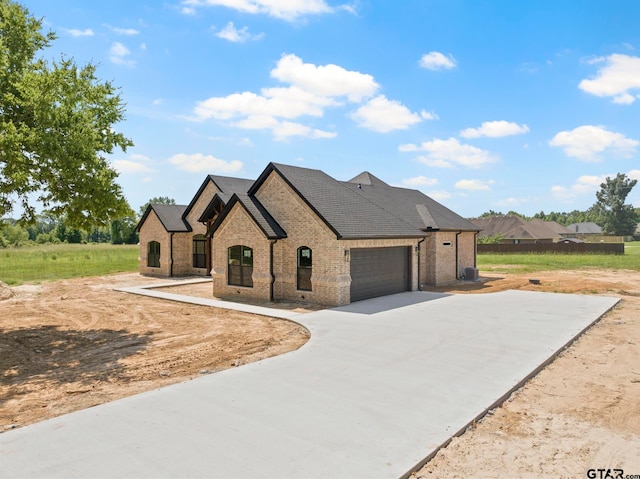 french country home with a garage