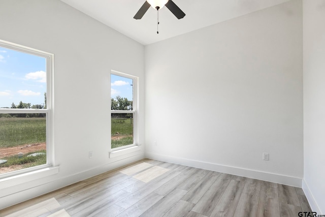 unfurnished room with ceiling fan, a healthy amount of sunlight, and light wood-type flooring