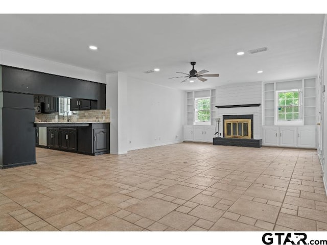 1812 Montrose Dr, Tyler, TX 75701 - unfurnished living room featuring ceiling fan, recessed lighting, a brick fireplace, plenty of natural light, and baseboards