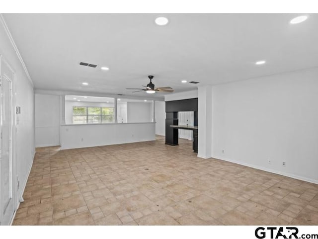 unfurnished living room with recessed lighting, a ceiling fan, and baseboards